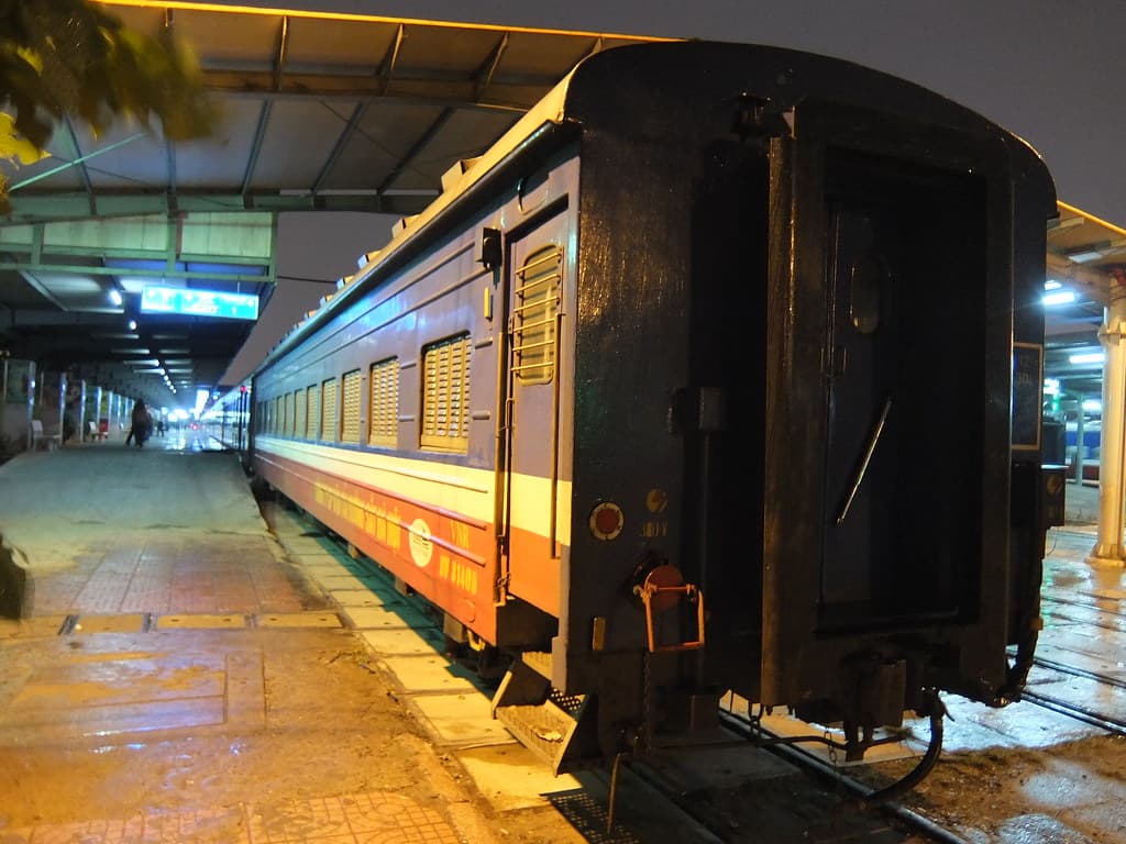 A ribbed bodied shuttered train car at Hanoi station
