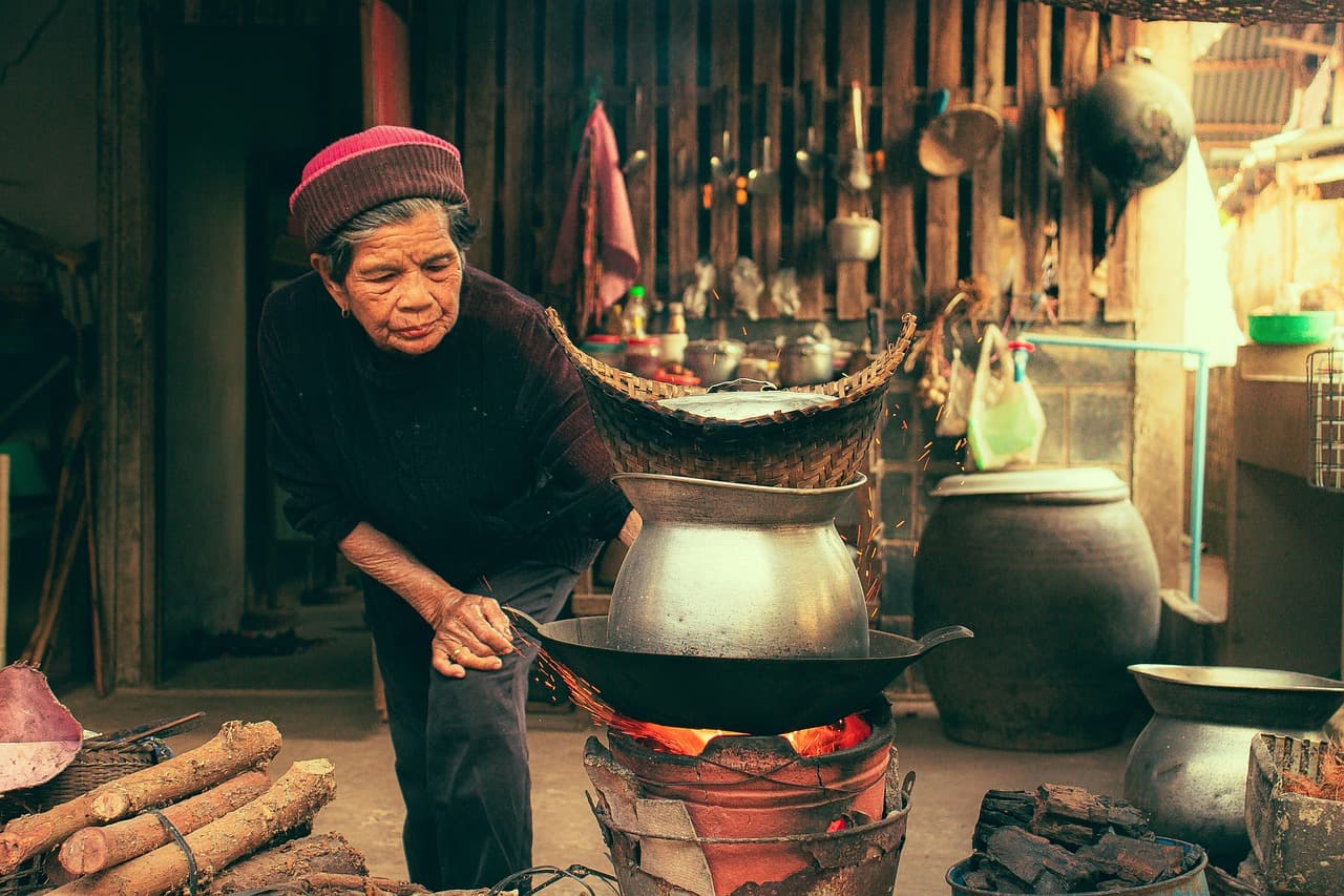 firewood, cooking, grandmother, woman, old, aged, senior, cook, pot, charcoal, rice, glutinous rice, sticky rice, breakfast, wood, kitchen, house, home