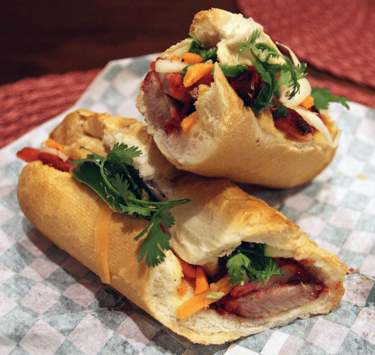 A close-up of a bánh mì sandwich showcasing its crispy baguette and colorful fillings.